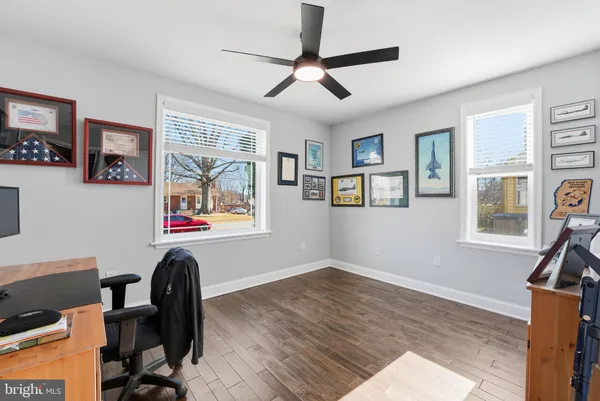 a workspace with wooden floor and a window
