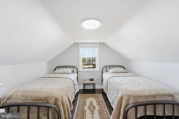 a bedroom with two beds and a chandelier