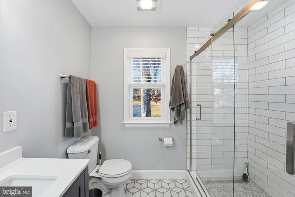 a bathroom with a toilet sink and shower