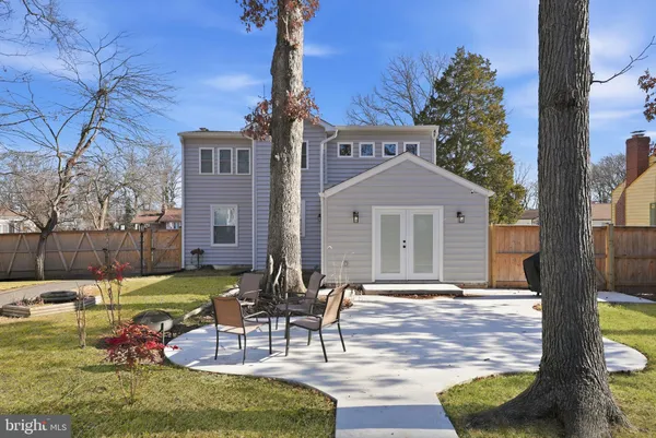 a front view of a house with garden and patio
