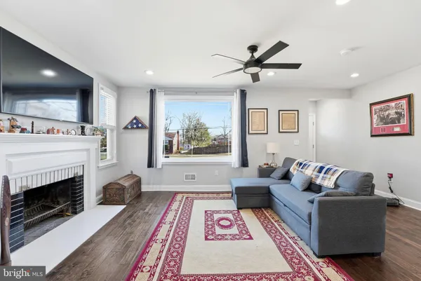 a living room with furniture and a fireplace