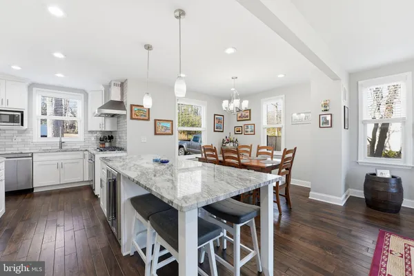 a large kitchen with a table and chairs