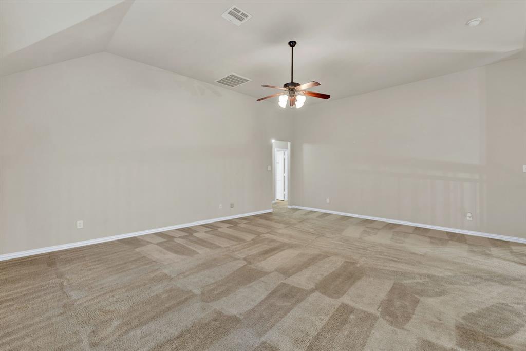 1701 Meadow Ranch Road McKinney, TX 75071 - Photo 22 of 40 a view of an empty room with a chandelier fan
