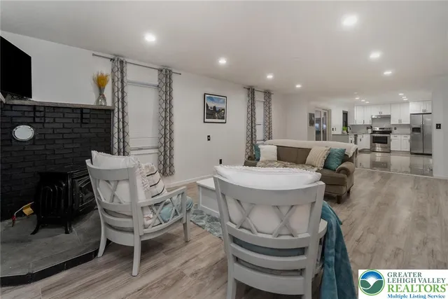 a large white kitchen with stainless steel appliances granite countertop a sink and cabinets