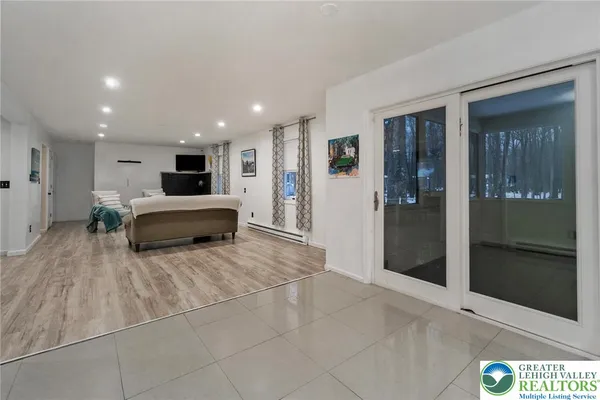 a large white kitchen with stainless steel appliances granite countertop a sink and cabinets