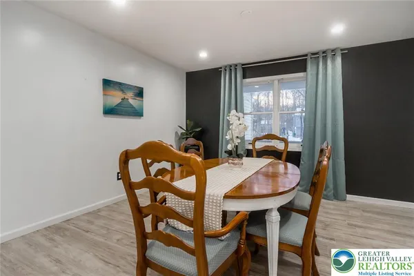 a view of a dining room with furniture window and wooden floor