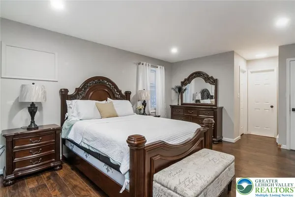 a bedroom with a bed and a dresser