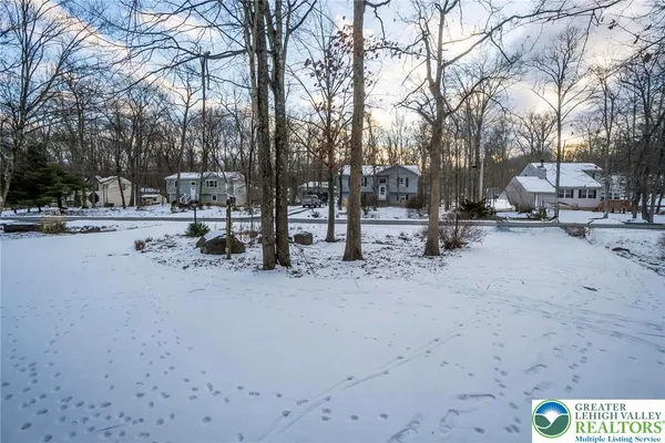 a view of a house with a snow in the yard