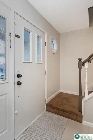a living room with stainless steel appliances kitchen island granite countertop a refrigerator and a sink
