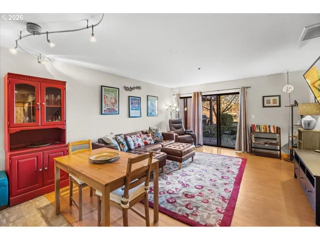 a living room with furniture a rug and a window