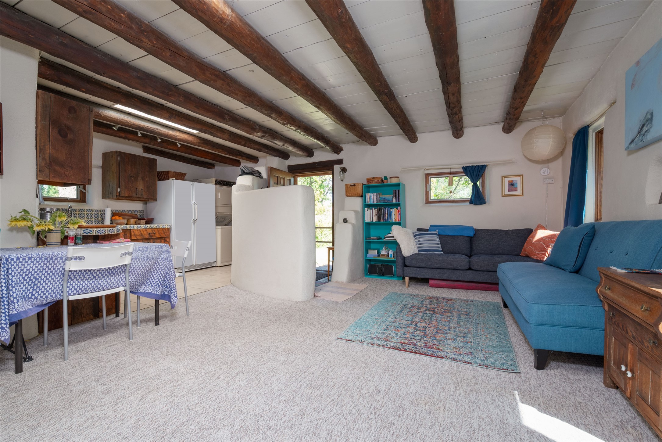 2175 Old Arroyo Chamiso Road, Unit 2 Santa Fe, NM 87505 - Photo 8 of 20 sofa and bookshelf in sleeping nook