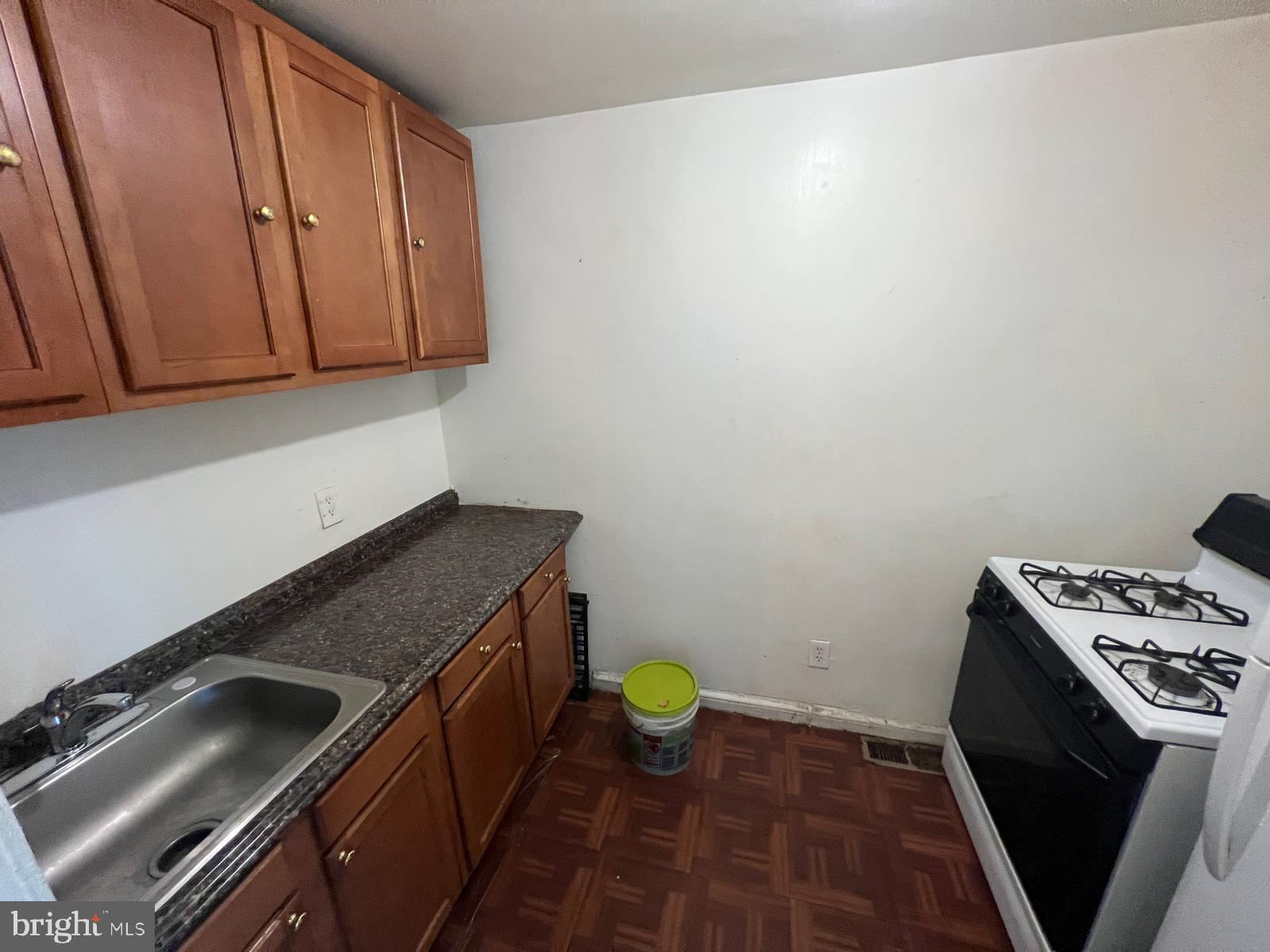 313 Cherry Hill Road Baltimore, MD 21225 - Photo 11 of 16 a kitchen with a stove and a sink