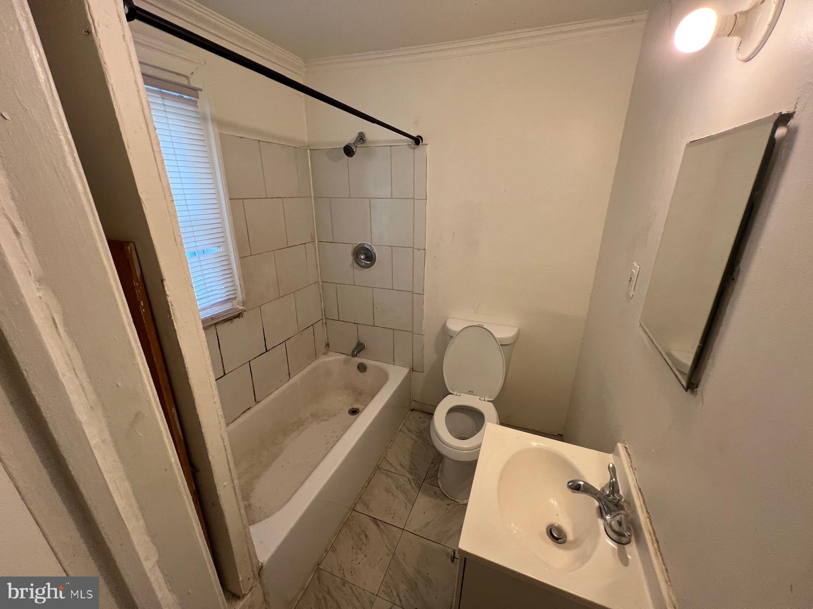 313 Cherry Hill Road Baltimore, MD 21225 - Photo 15 of 16 a bathroom with a tub shower and a sink