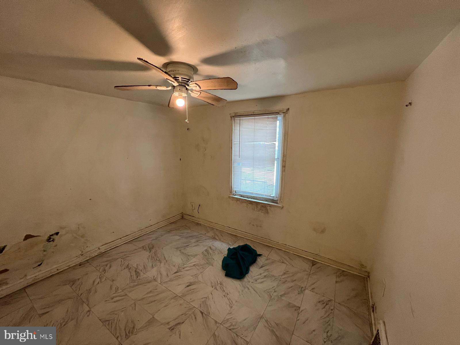 313 Cherry Hill Road Baltimore, MD 21225 - Photo 6 of 16 a bathroom with a window and a fan