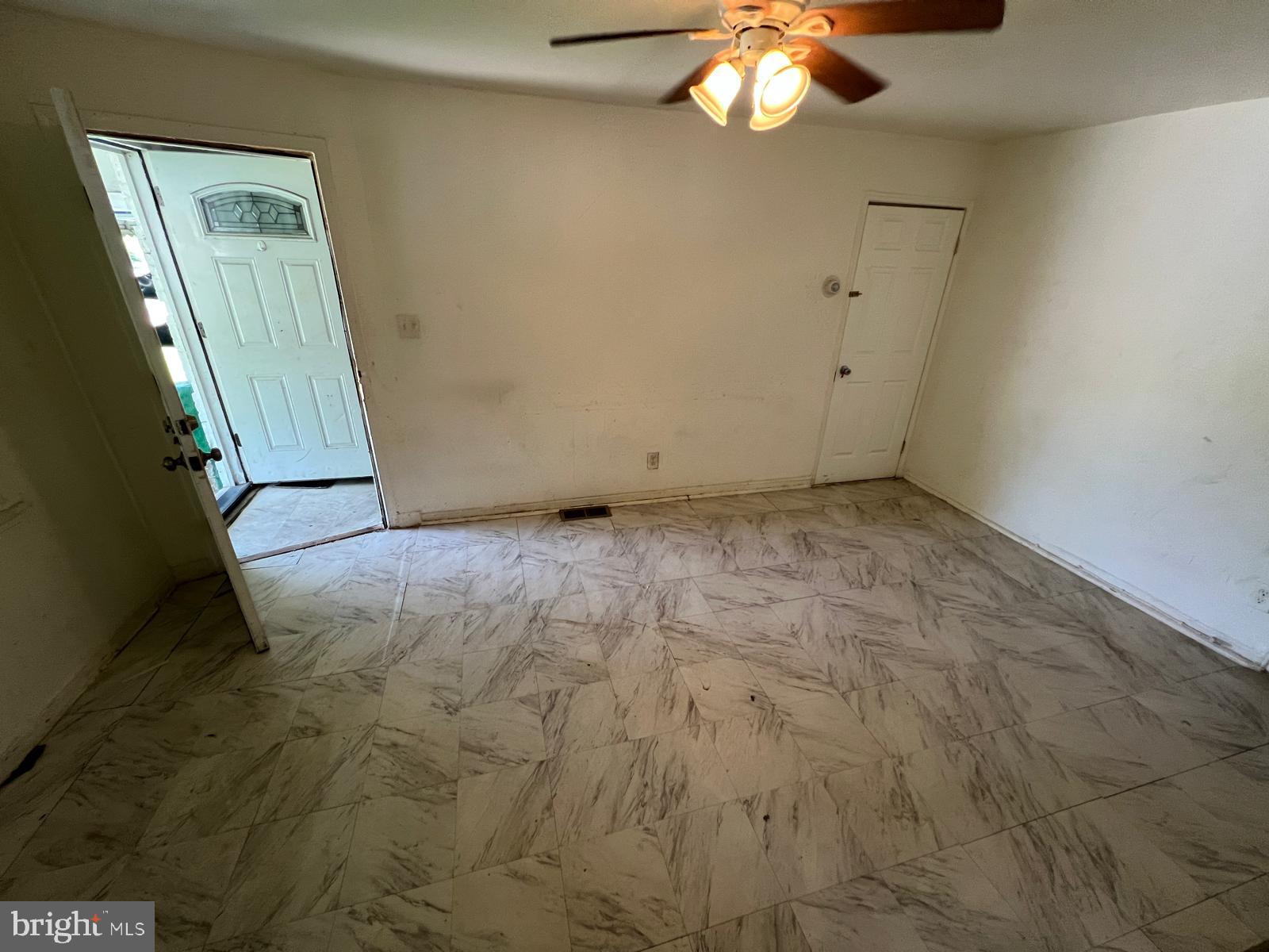 313 Cherry Hill Road Baltimore, MD 21225 - Photo 10 of 16 a view of an empty room with a chandelier fan