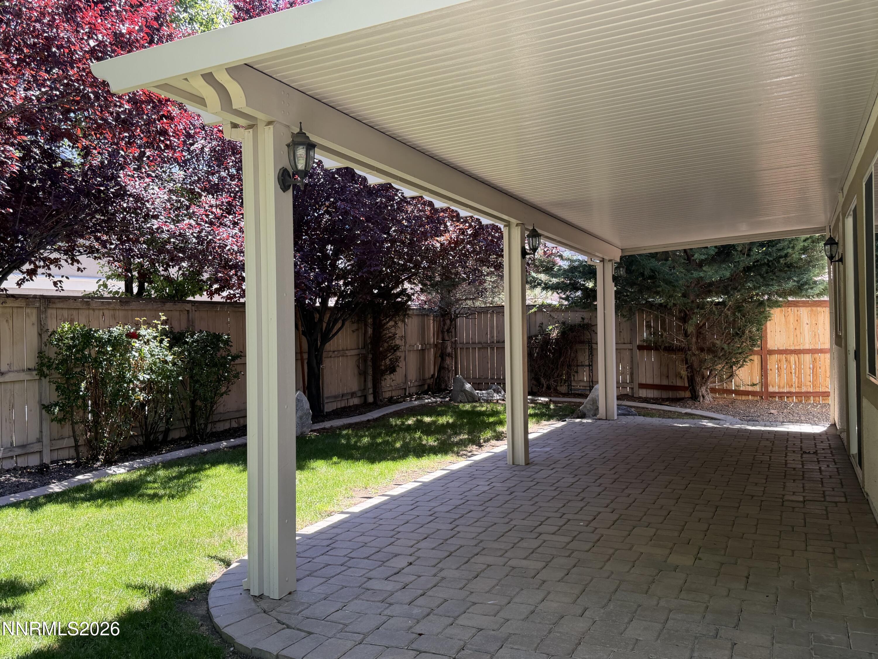 10890 Oakhaven Drive Reno, NV 89521 - Photo 9 of 28 a view of a patio with a table and chairs under an umbrella