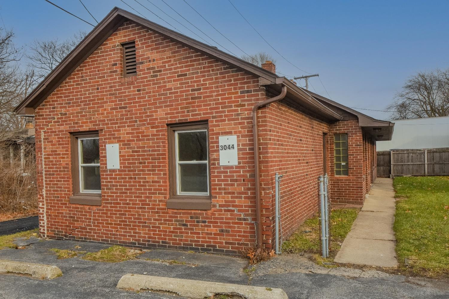 3044 West Ridge Road, Unit RD Gary, IN 46408 - Photo 1 of 13 a view of a house with wooden fence