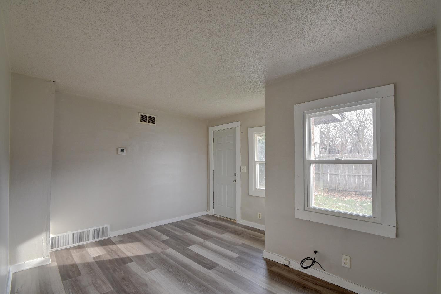 3044 West Ridge Road, Unit RD Gary, IN 46408 - Photo 6 of 13 a view of a room with wooden floor and windows