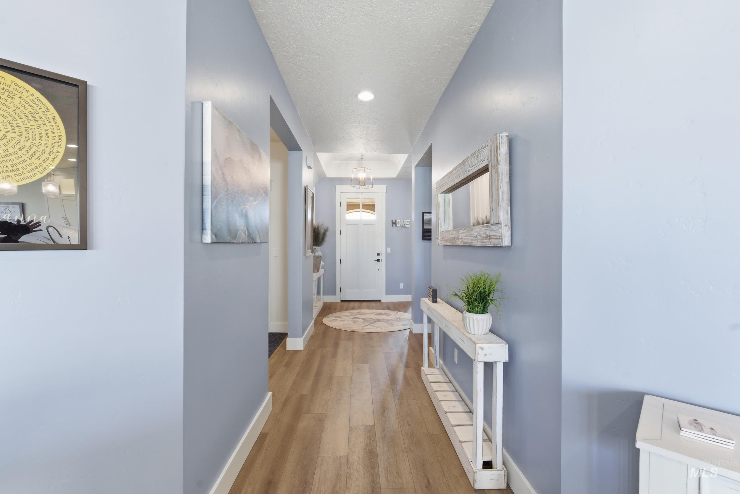 6347 South Utmost Lane Meridian, ID 83642 - Photo 6 of 37 Inviting entryway featuring wood-finish flooring, white baseboards, and light blue wall tones