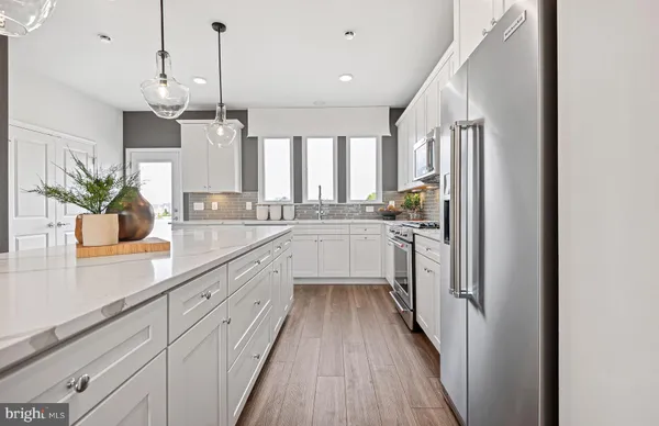 a kitchen with sink cabinets and wooden floor