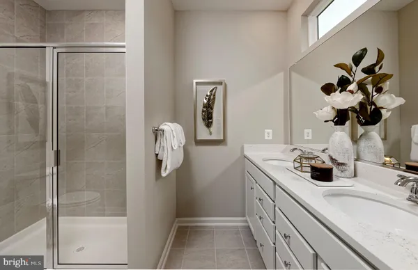 a bathroom with a sink a mirror and shower