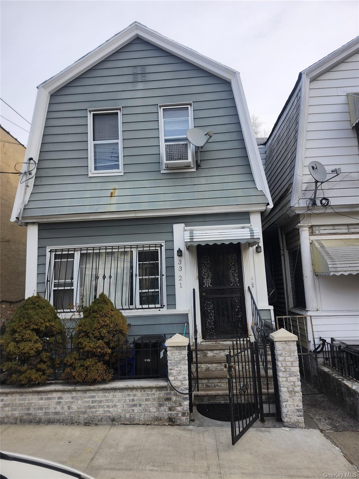 33-21 112th Street, Unit 2 Queens, NY 11368 - Photo 1 of 9 a front view of a house with garage