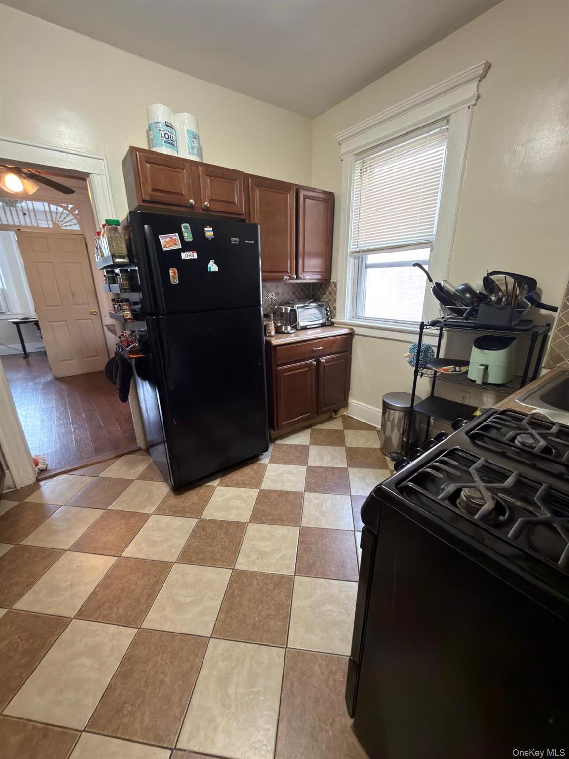 33-21 112th Street, Unit 2 Queens, NY 11368 - Photo 5 of 9 a kitchen with stainless steel appliances granite countertop a refrigerator and a stove top oven