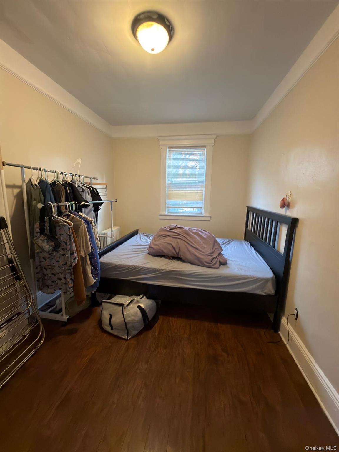 33-21 112th Street, Unit 2 Queens, NY 11368 - Photo 7 of 9 a bedroom with a bed and wooden floor