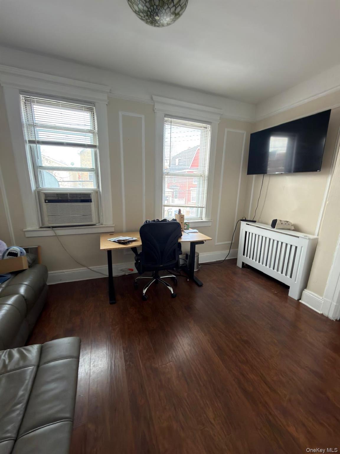 33-21 112th Street, Unit 2 Queens, NY 11368 - Photo 8 of 9 a living room with furniture and a flat screen tv