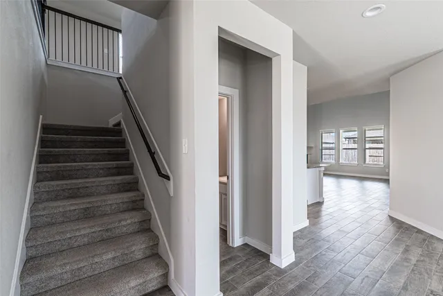 a view of entryway and hall with wooden floor
