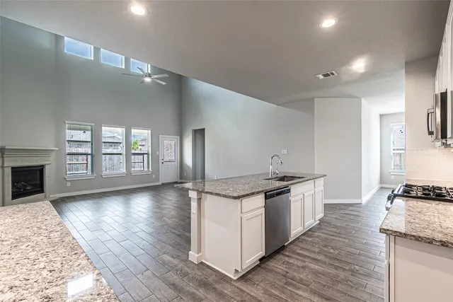 a kitchen with stainless steel appliances granite countertop a stove and a sink