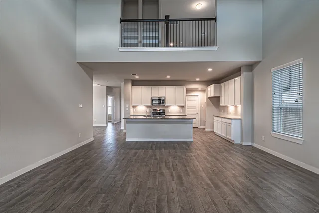 a view of kitchen with refrigerator and window