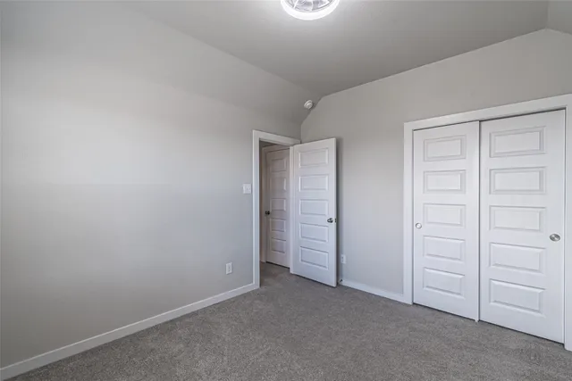 an empty room with closet area