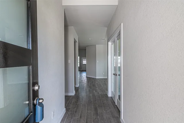 a view of a hallway with wooden floor