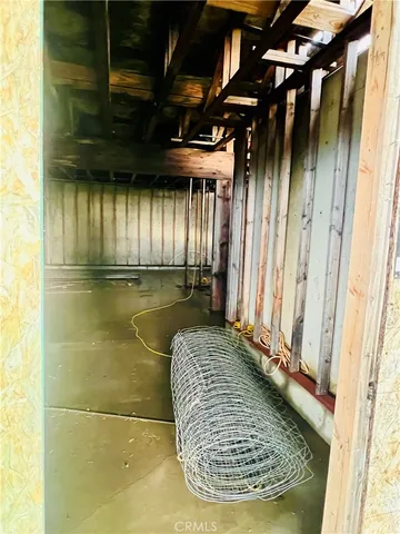a view of a porch with a wooden door and bench