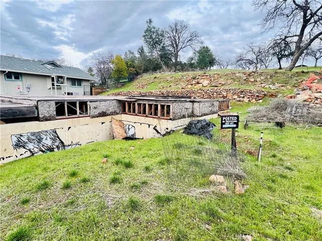 a view of an house with backyard space and garden