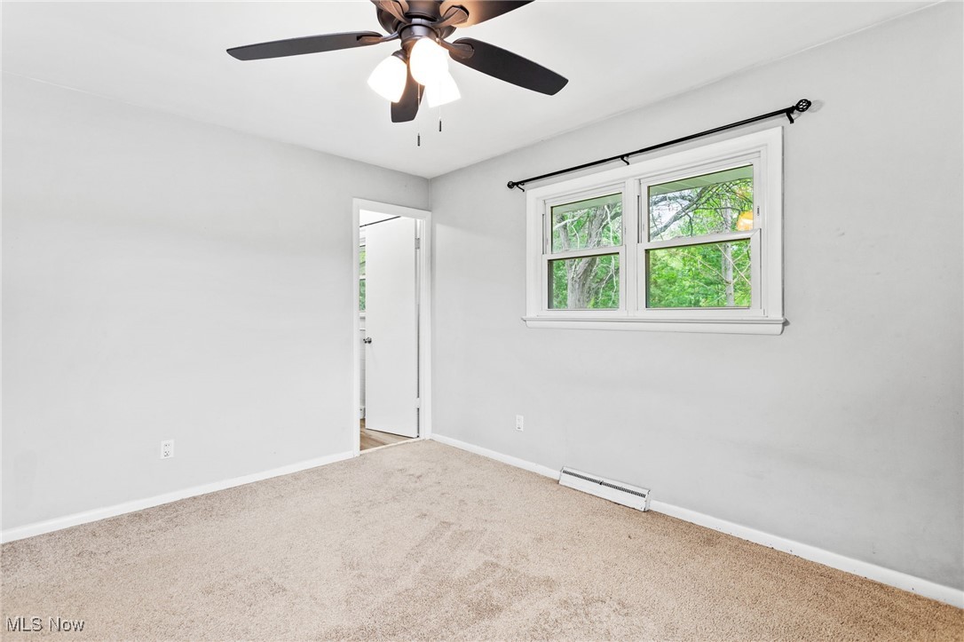 7654 Ragall Parkway Cleveland, OH 44130 - Photo 19 of 33 Unfurnished room featuring carpet, a ceiling fan, and a baseboard radiator