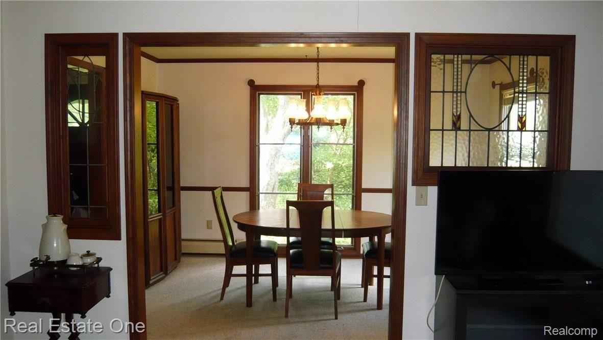 9639 Currie Road Northville, MI 48167 - Photo 13 of 24 STAINED GLASS WINDOWS SEPARATE DINING FROM LIVING AREA