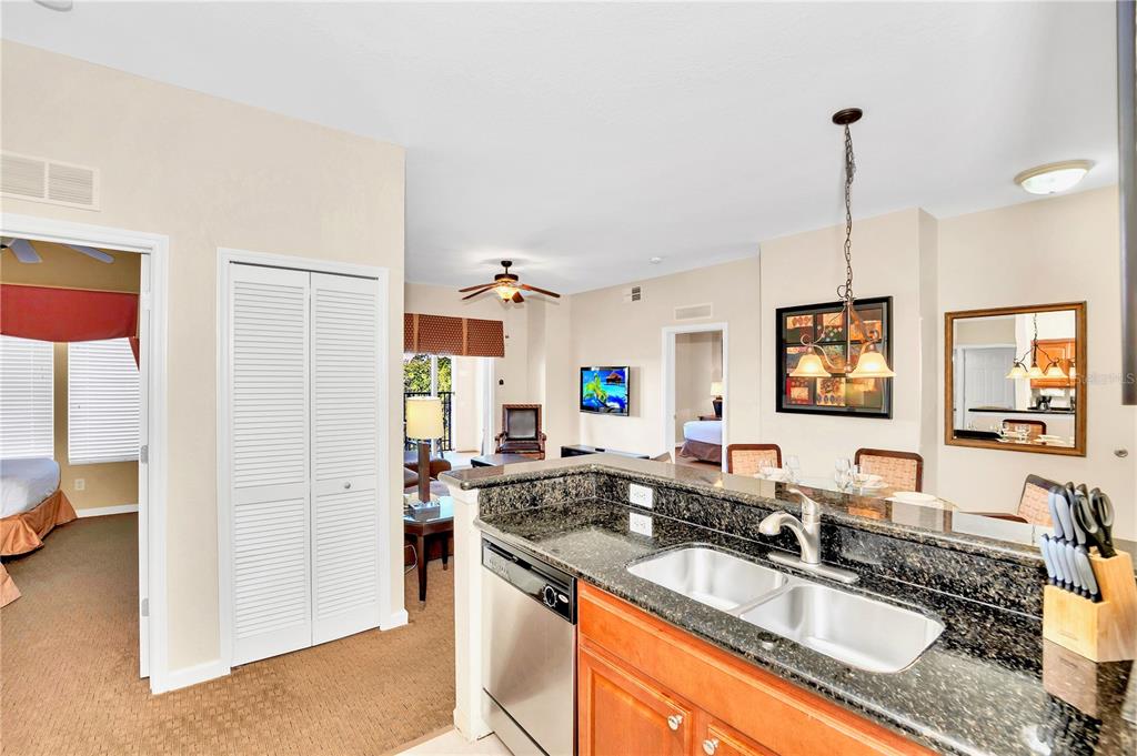 8113 Resort Village Drive, Unit 4405 Orlando, FL 32821 - Photo 13 of 25 a kitchen with a sink stove and refrigerator