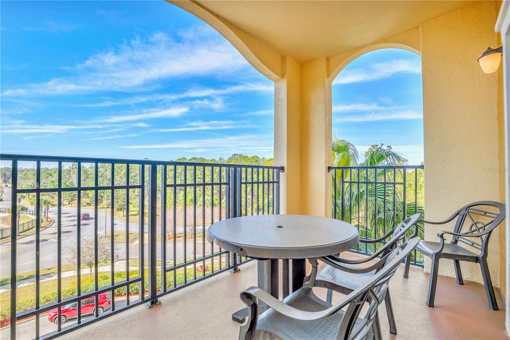 8113 Resort Village Drive, Unit 4405 Orlando, FL 32821 - Photo 23 of 25 a view of a balcony with furniture