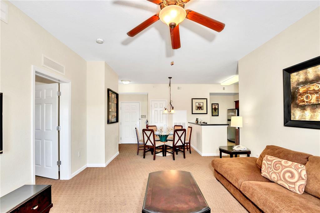 8113 Resort Village Drive, Unit 4405 Orlando, FL 32821 - Photo 9 of 25 a living room with furniture and wooden floor
