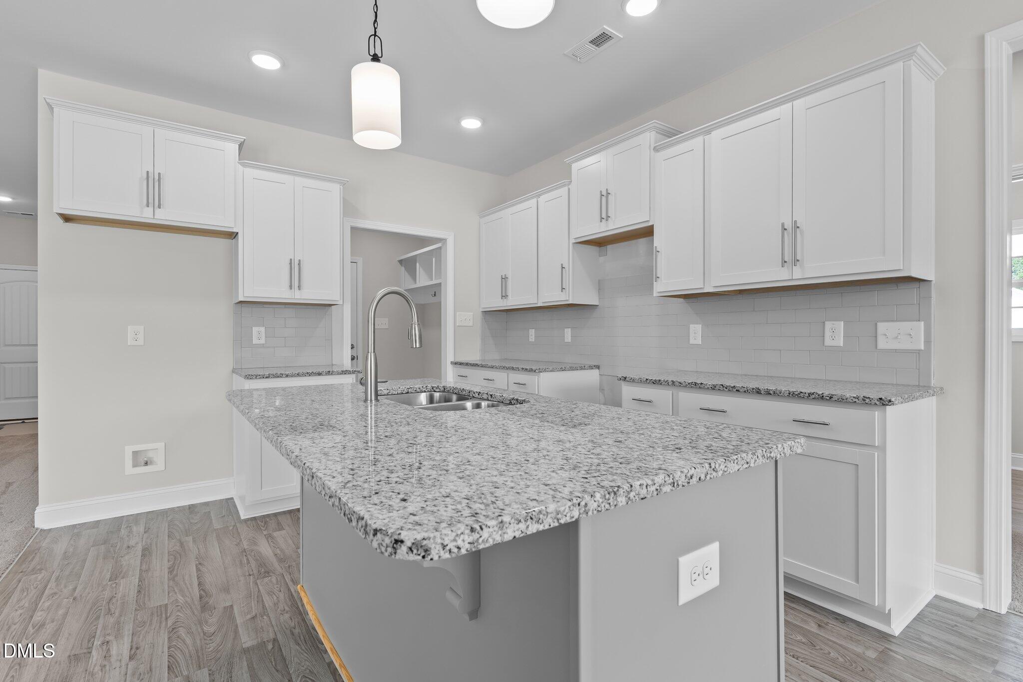 506 Bill Avery Road Coats, NC 27521 - Photo 10 of 21 a kitchen with stainless steel appliances granite countertop a sink stove and refrigerator