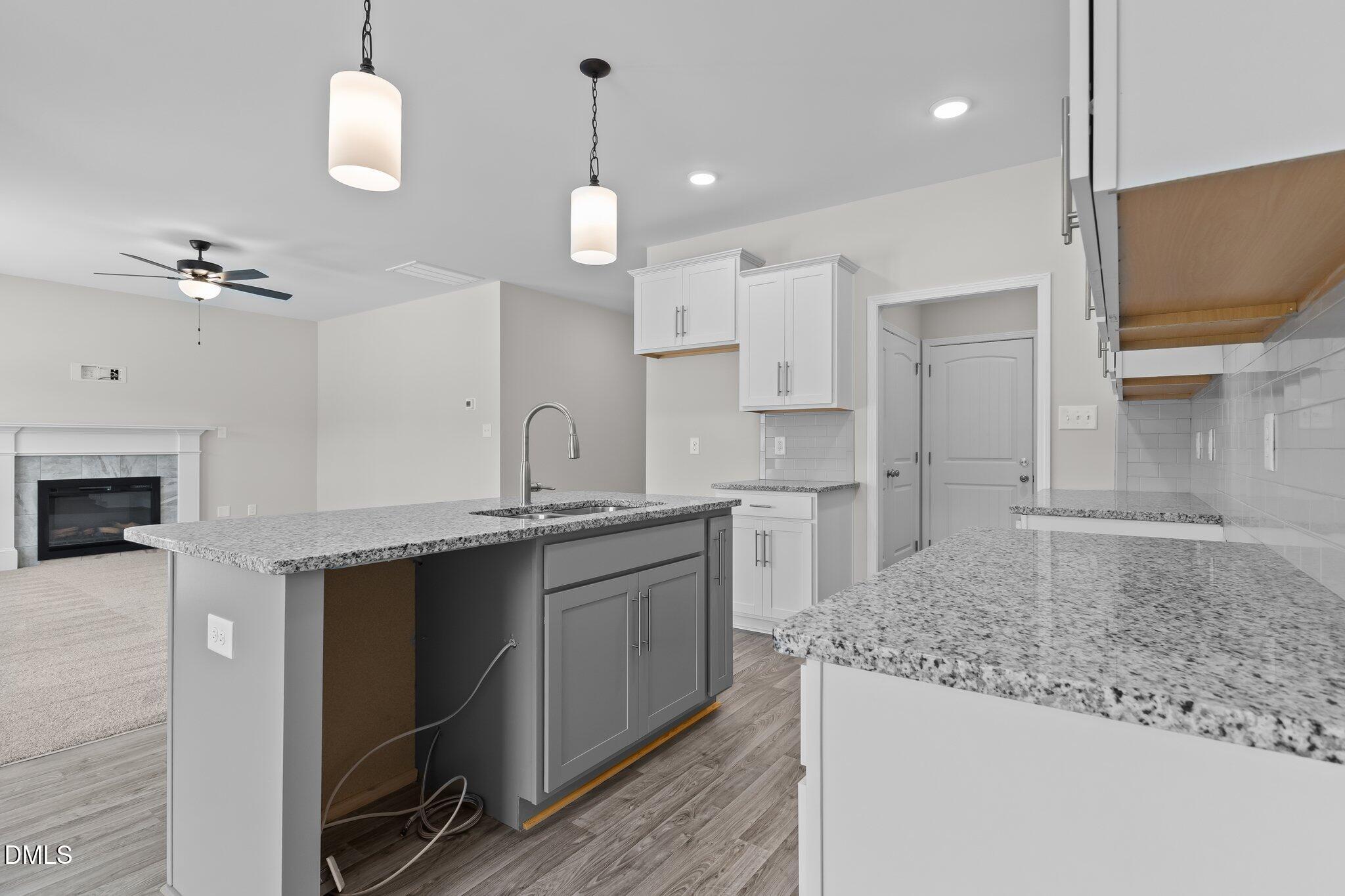 506 Bill Avery Road Coats, NC 27521 - Photo 6 of 21 a kitchen with kitchen island a sink stainless steel appliances and cabinets
