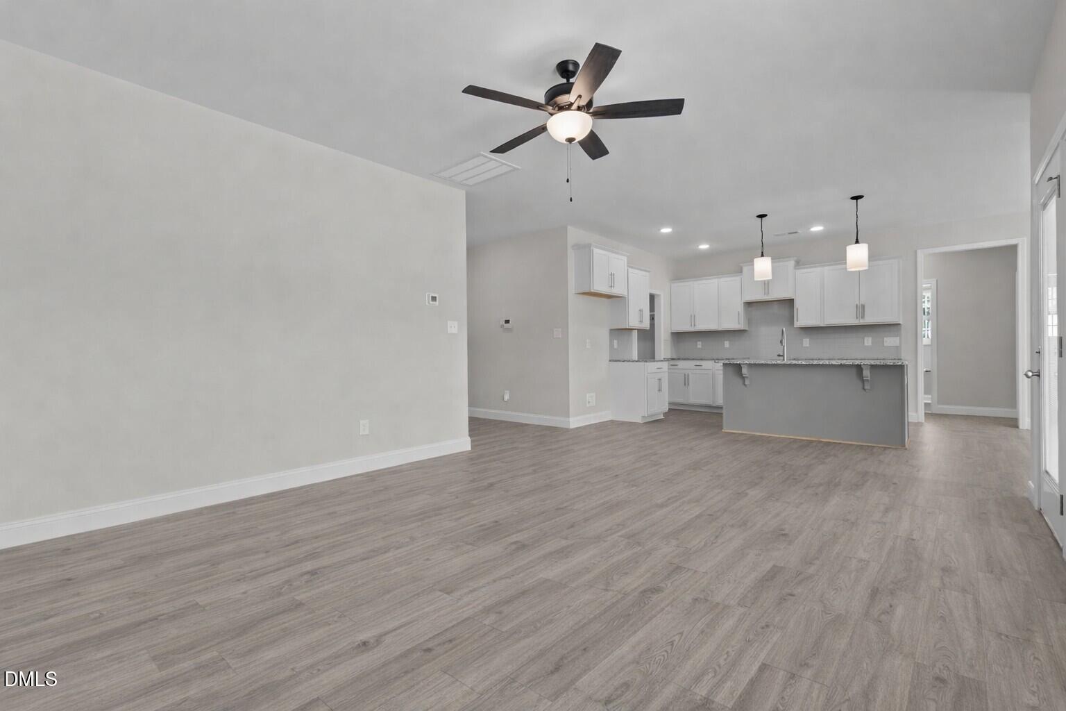 506 Bill Avery Road Coats, NC 27521 - Photo 8 of 21 a view of a kitchen with a stove and a ceiling fan