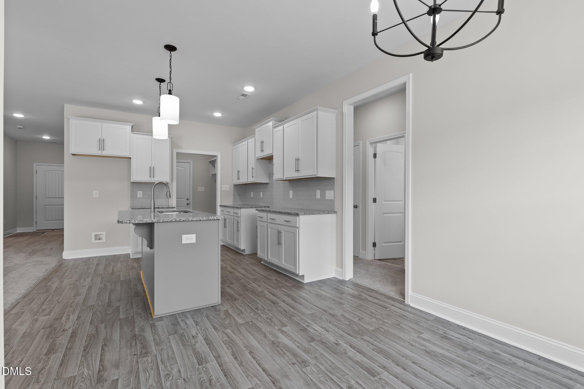 506 Bill Avery Road Coats, NC 27521 - Photo 9 of 21 a large kitchen with cabinets wooden floor and stainless steel appliances