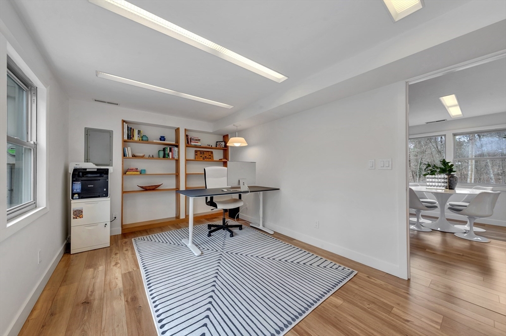 85 The Valley Road Concord, MA 01742 - Photo 31 of 38 a view of a workspace with furniture and wooden floor