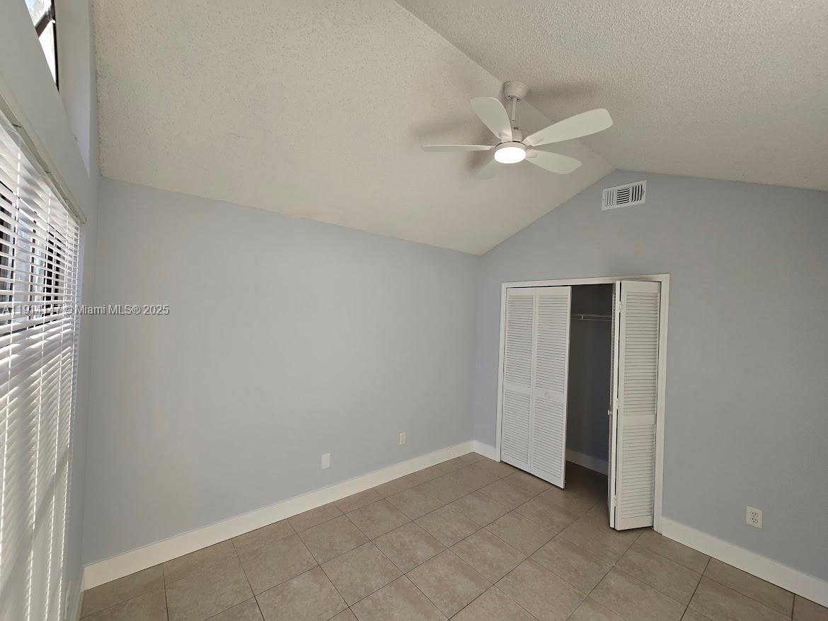 Lakes at Boca Raton Boca Raton, FL 33498 - Photo 5 of 18 an empty room with closet and a chandelier fan