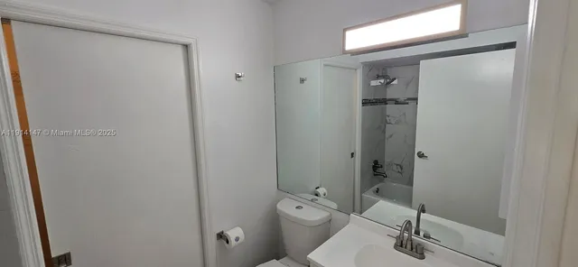 a bathroom with a toilet a sink and shower