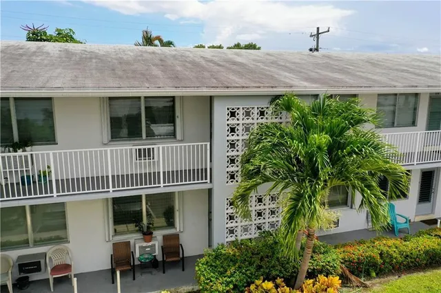 a view of a house with a deck and a yard