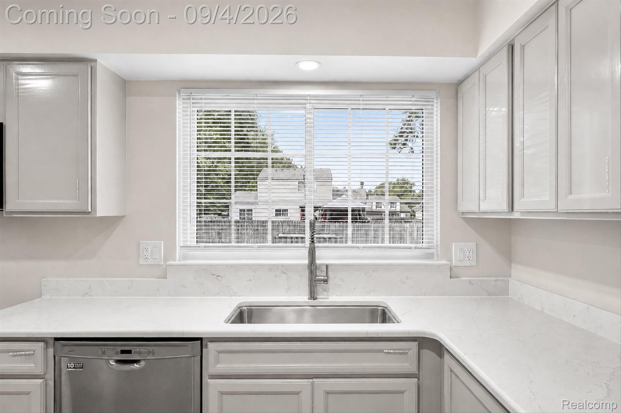 43182 Applewood Road Canton, MI 48188 - Photo 5 of 36 White cabinetry, stainless steel dishwasher, undermount sink with a gooseneck faucet, and light-colored countertops
